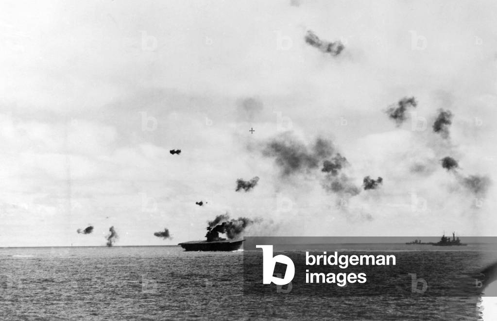The aircraft carrier USS Yorktown being hit by dive bombers at the Battle of Midway, 1942