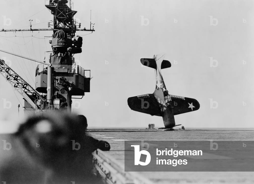 Douglas Dauntless dive bomber balanced on nose after crash landing on carrier flight deck. June 21, 1943. World War 2, Pacific Ocean