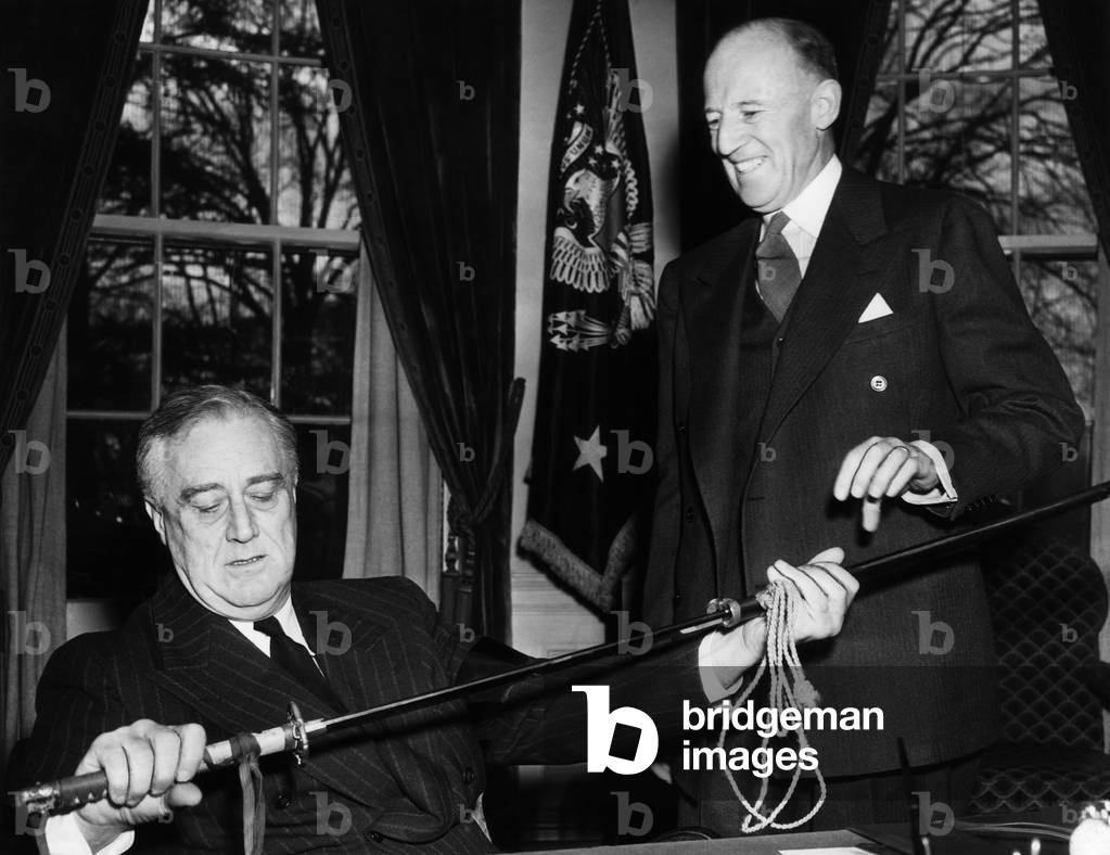 President Franklin D. Roosevelt (left), receives the saber of a dead Japanese officer, the gift of General Douglas MacArthur. from Francis B. Sayre (right), U.S. High Commissioner to the Philippines, March 23, 1942
