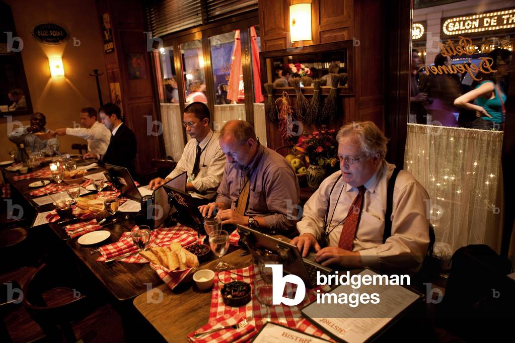 Photojournalists in the traveling press pool transmit their photoswhile traveling to New York City with President and Michelle Obama May 30 2009. From center-left Mandel Ngan of Agence France-Presse Jonathan Ernst of Reuters and J. Scott Applewhite of the Associated Press.,
