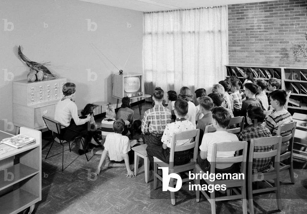 Students and their teacher watch educational television in a school library in Schenectady, New York, 1954