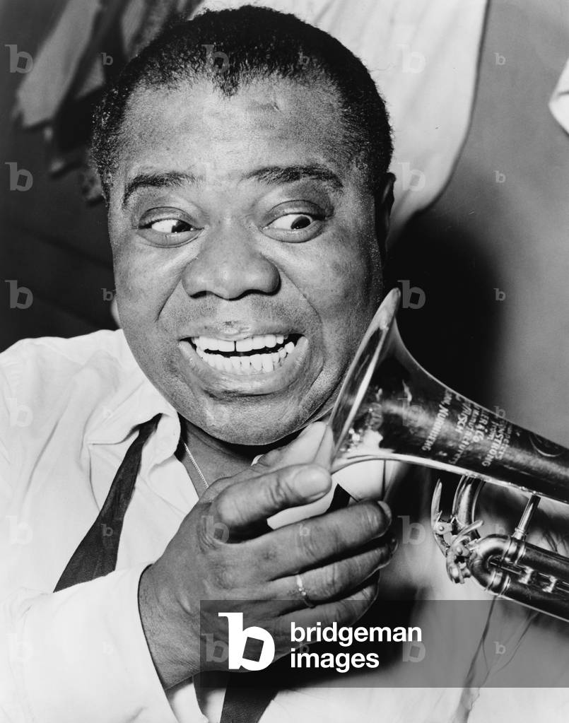 Louis Armstrong (1901-1971), African American Jazz musician, with his trademark smile and trumpet, 1953