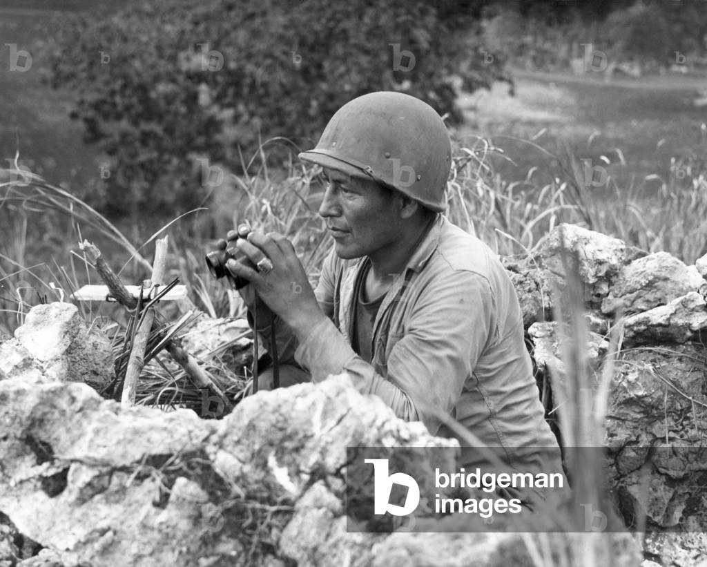 Native American Marine 'Code Talker' at an observation post overlooking the city of Garapan. During the Battle of Saipan. June 27, 1944, World War 2