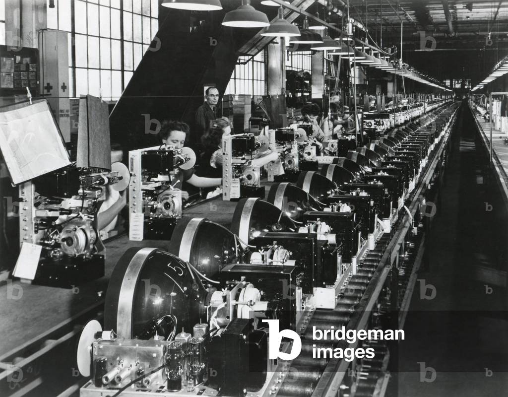 Television chassis on an assembly line with women workers in a U.S. factory. July 1949.
