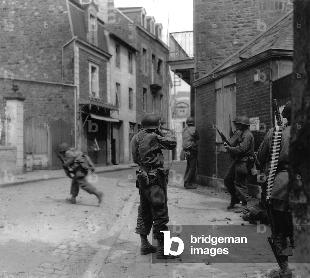 U.S. soldier aims at a German sniper during street fighting in Saint Malo, France, Aug. 8, 1944. The Atlantic port city was captured on Aug. 17, 1944, with the 10,000 German POWS. World War 2