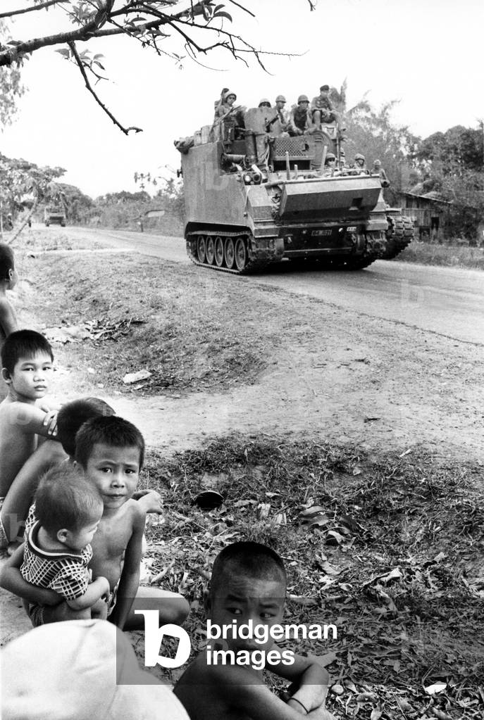 Highway 22, youngsters watch So.Vietnamese troops en route to Tay Ninh, 3/17/75.