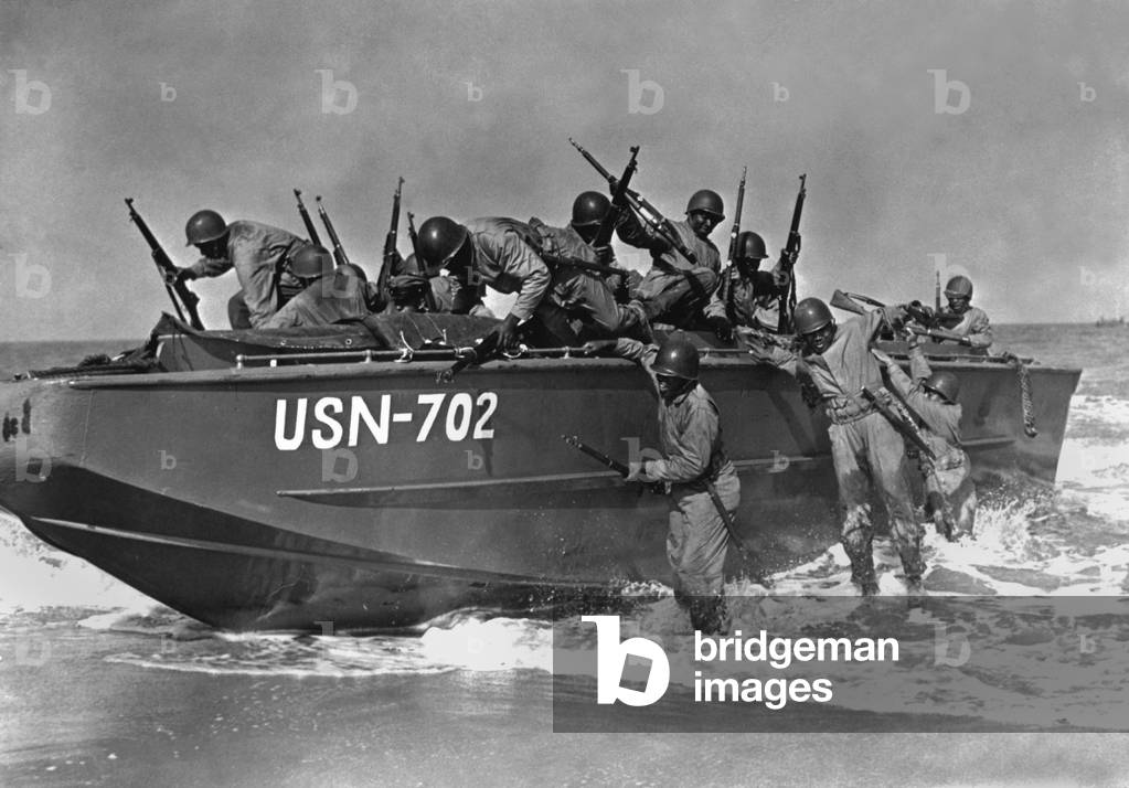 African American sailors training for amphibious landings at near Norfolk, Virginia, c. 1942. They are Navy Seabees, members of Naval Construction Battalions during World War 2