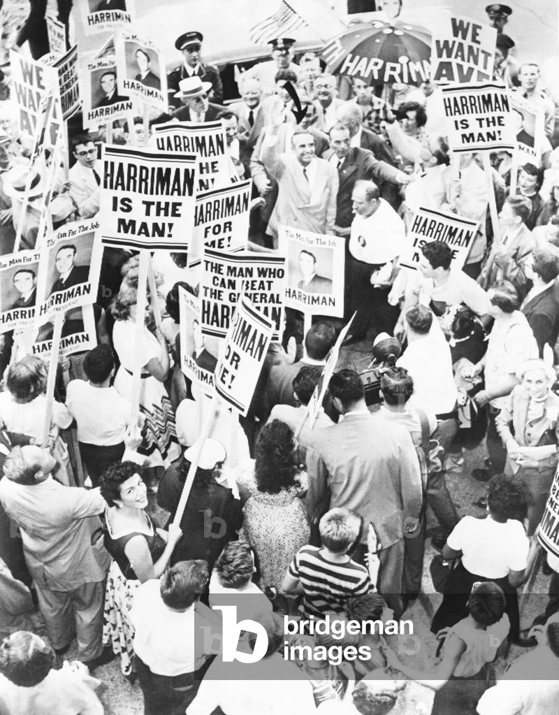 Democratic Presidential hopeful, Averill Harriman waves to crowd, in Chicago, July 17, 1952. The New York Delegation greets him with signs. Harriman was initially supported by President Truman, who later recruited Adlai Stevenson, who had more political experience