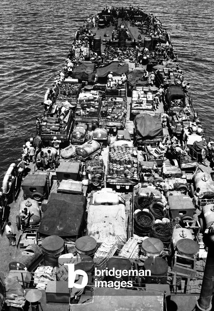 Coast Guard-manned LST crammed with Marines and material for the invasion of New Britain against the Japanese. Soldiers joked that LST stood for 'Large Slow Target' instead of 'Landing Ship Tank'. Dec. 23, 1943