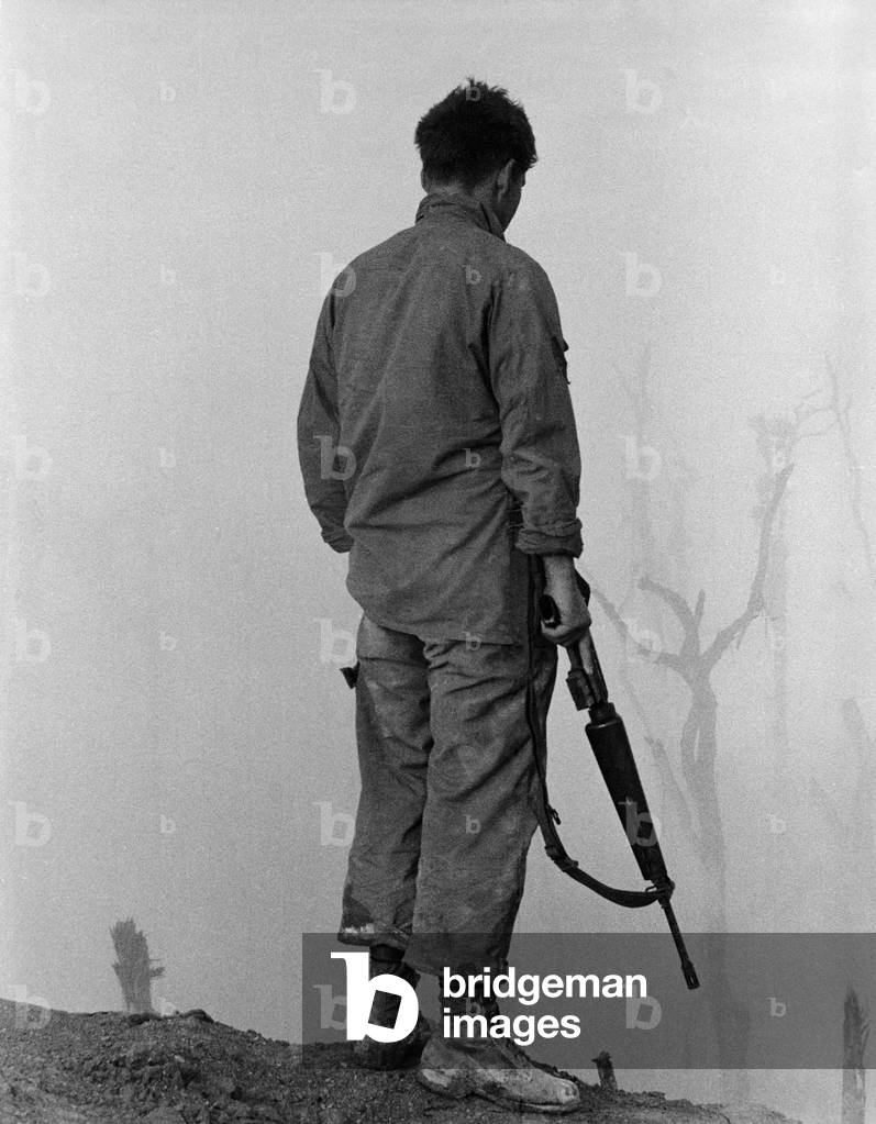 Vietnam War. US Infantryman looks over the fog-shrouded A Shau Valley, a major arm of the Ho Chi Minh Trail. 1969