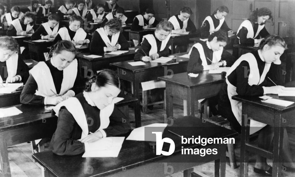 Soviet female graduates from the tenth grade writing compositions for their diplomas. Yaroslavl, USSR. 1948.
