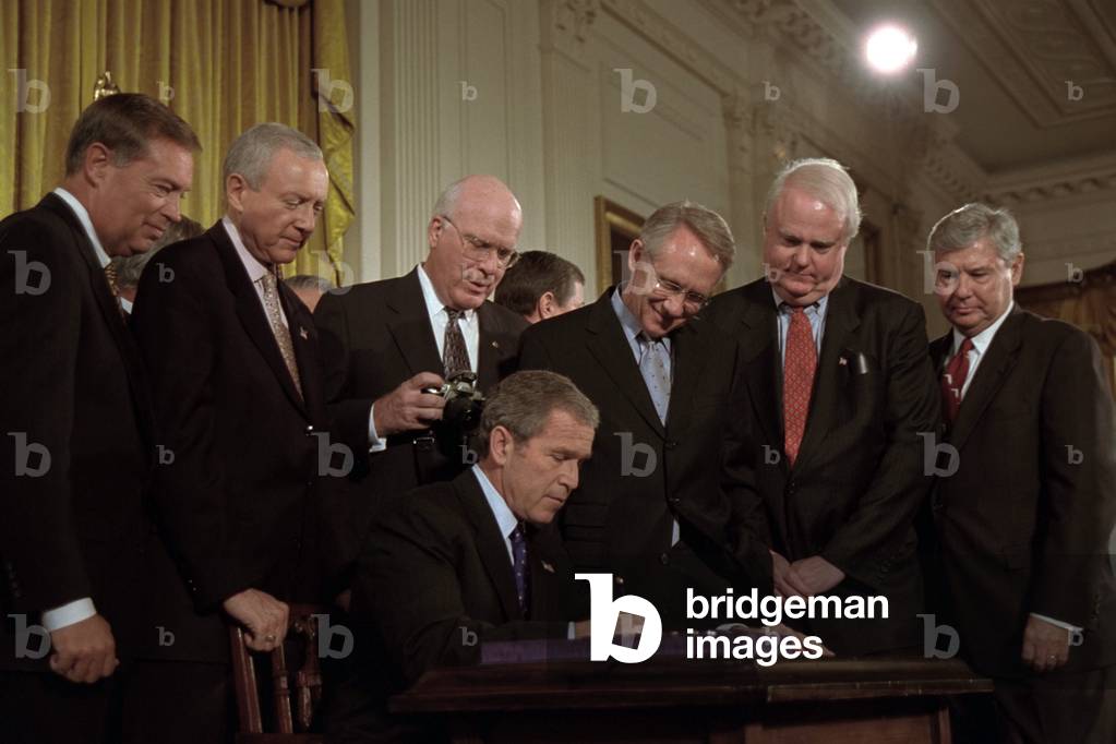 President George W. Bush signs the USA Patriot Act on Oct. 26,2001. 'This new law that I sign today will allow surveillance of all communications used by terrorists, including e-mails, the Internet, and cell phones.' Standing behind Bush 43 from left are: U.S. AG, John Ashcroft; Sen. Orrin Hatch; Sen. Patrick Leahy; Sen. Harry Reid; Rep. James Sensenbrenner, and Sen. Bob Graham