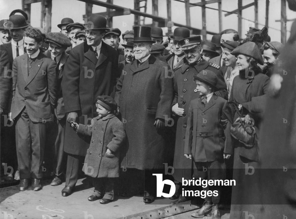 Franklin Roosevelt as Assistant Secretary of Navy. Roosevelt is wearing a bowler hat and holding a child's hand at the Brooklyn Navy Yard for the keel laying of the USS Arizona on March 16 1914