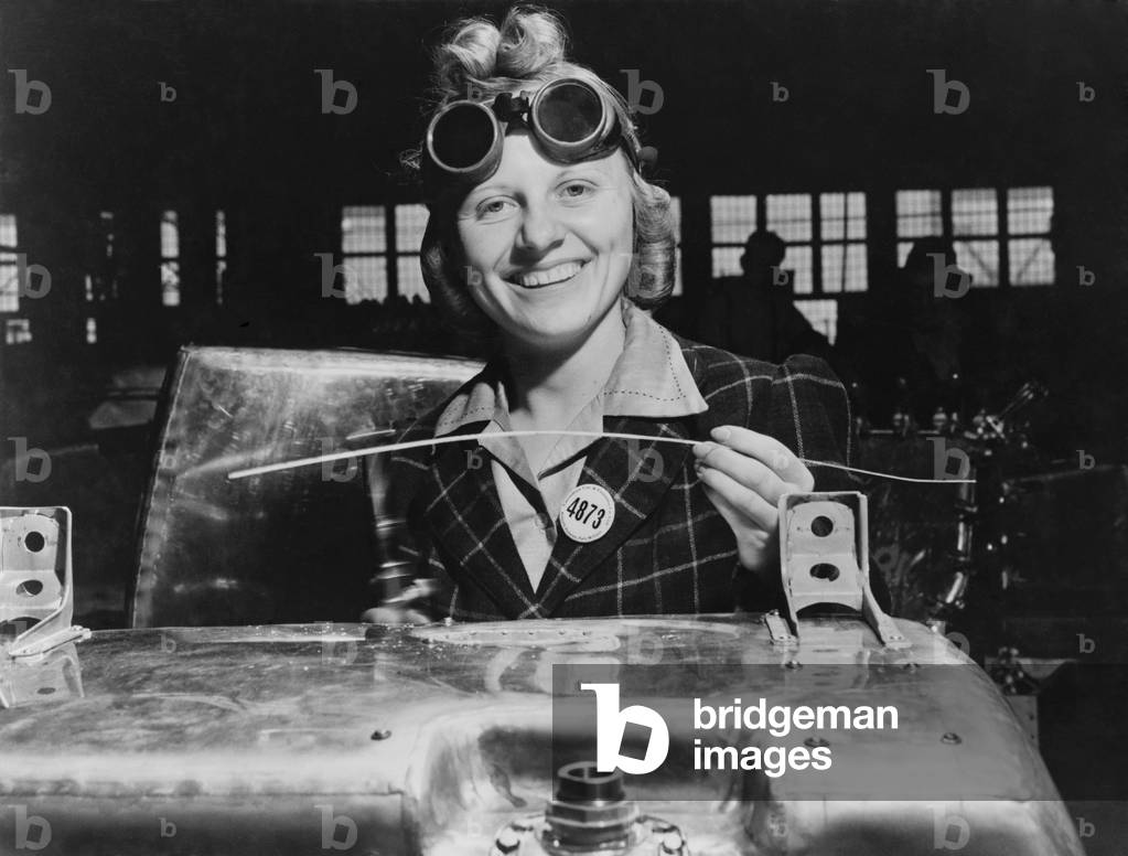 Woman welding a fuel tank for a Hawker Hurricane fighter airplane at Fort William, Ontario, Canada. 1941. World War 2
