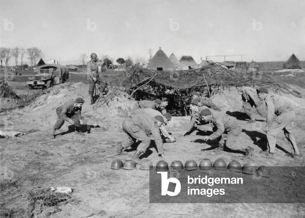 American soldiers of a field artillery battalion, playing football while off duty. They are on the Anzio Beachhead near Nettuno on Feb. 5, 1944, before German forces massed in the nearby hills for a four month siege. World War 2