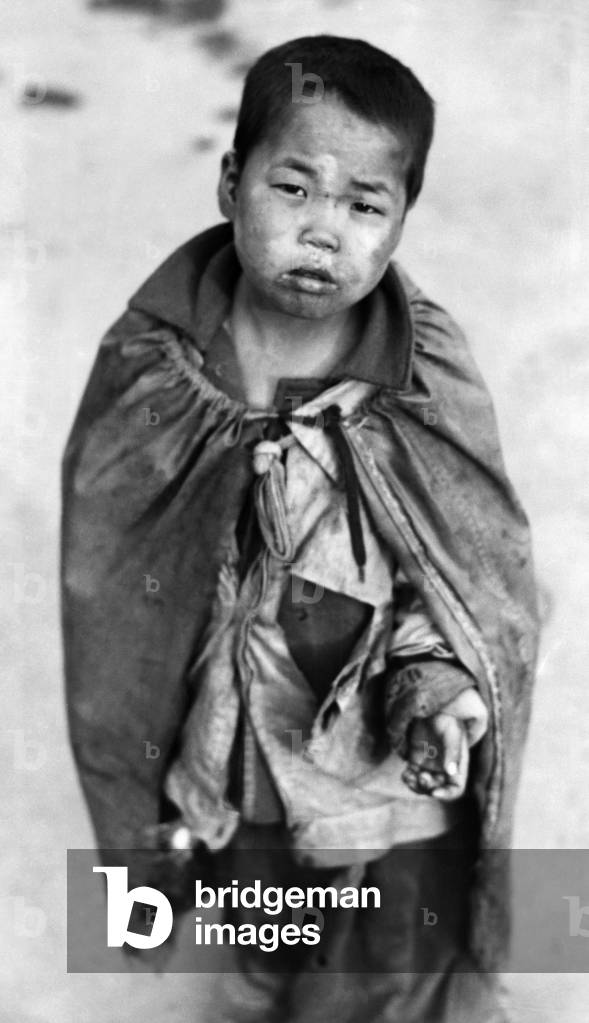 Korean War: A young Korean boy begging for food, Pusan, Korea, 1953.