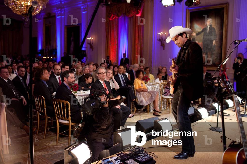 Country singer Brad Paisley performs at a celebration of country music hosted by President and Michelle Obama celebrating country music in the East Room on July 21 2009.,