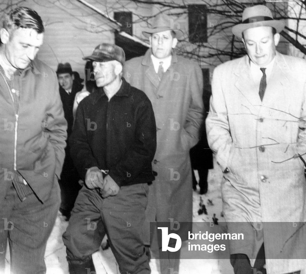 Serial Killer Ed Gein is led away from his farm by detectives, Plainfield, Wisconsin, November 18, 1957