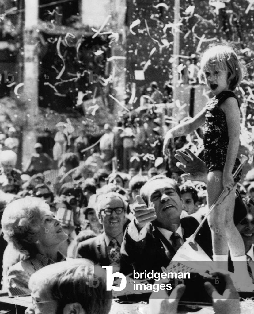 Nixon Presidency. From left: First Lady Patricia Nixon and US President Richard Nixon looking up at majorette mascot Rachel Lane at a ticker tape parade in Atlanta, Georgia, 1972
