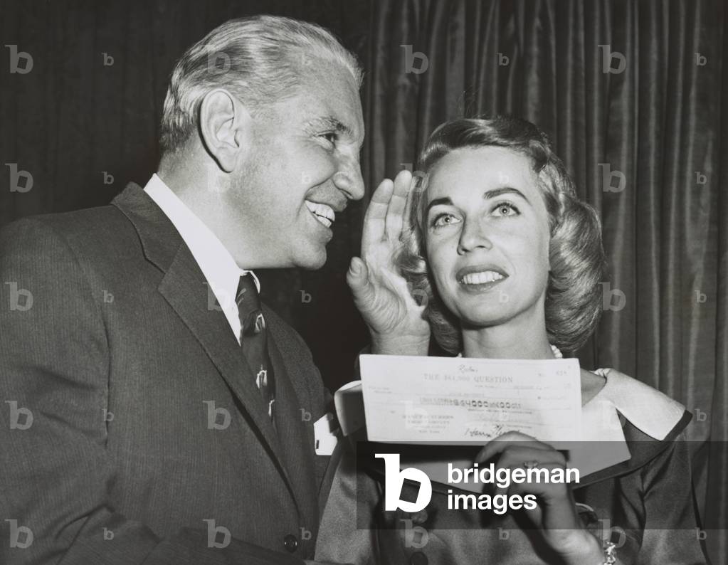 Dr. Joyce Brothers holds her check for correctly answering the ,000 Question. Because her quiz show topic was 'Boxing' she was congratulated by New York State Athletic Commissioner Col. Edward Egan. Dec. 1955.
