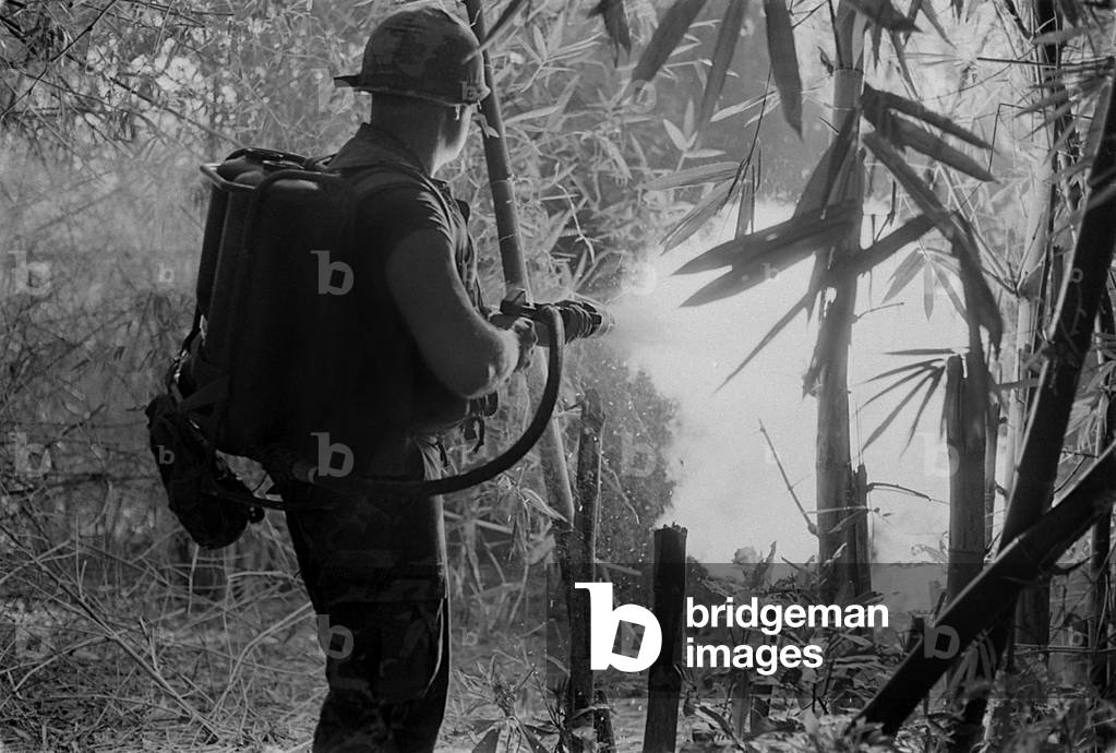 Vietnam War. US Soldier clears a jungle area with his flame thrower. May 22, 1970