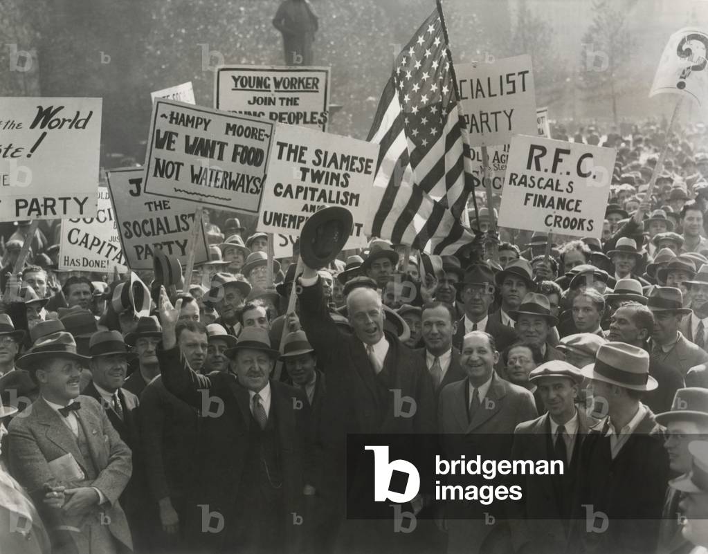Norman Thomas, 1932 Socialist presidential nominee in Philadelphia, Oct. 28, 1932. Thomas is in center front waving his hat. At his right is James Maurer, his Vice Presidential running mate. Signs read: Siamese Twins, Capitalism and Unemployment; Join the Socialist Party; We Want Food, Not Waterways