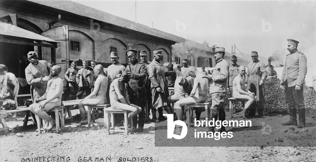 World War 1. Disinfecting German soldiers. Soldiers in French uniforms shave hair from German POWs to prevent lice borne disease. c. 1914-18
