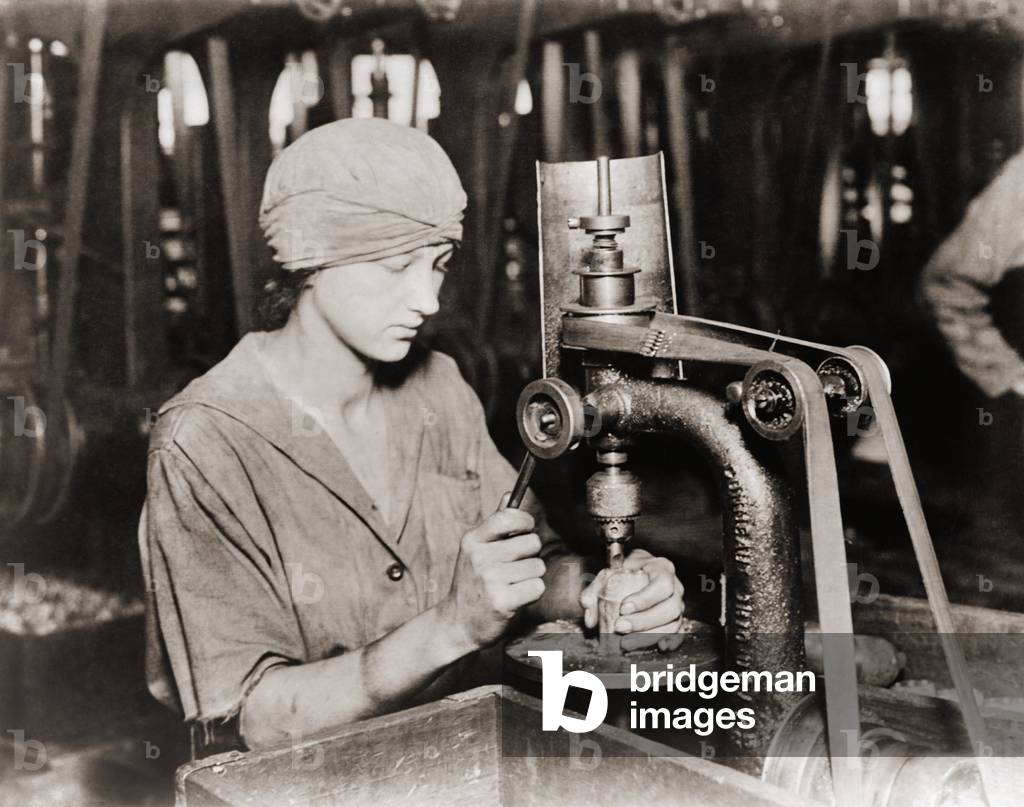 Woman countersinking a detonator tube hole in hand grenade at Westinghouse Electric & Manufacturing. Company, during World War I