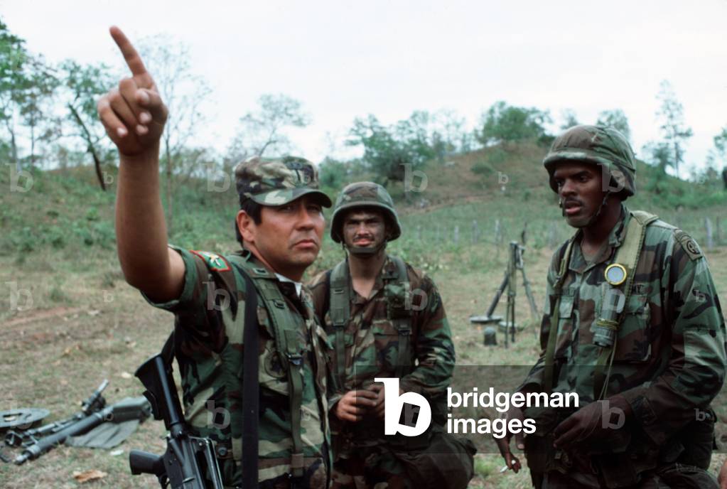 A Honduran Second Lieutenant talks with American soldiers from the 82nd Airborne Division during joint exercises in Judicalpa Honduras. Mar. 1 1988., Photo by:Everett Collection