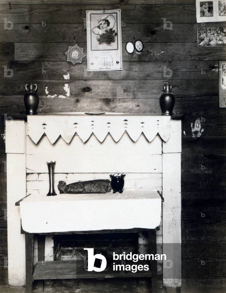 Fireplace in the bedroom of Floyd Burroughs, cotton sharecropper, Hale County, Alabama. Hale County, Alabama. Published in the book, 'Let Us Now Praise Famous Men'. photograph by Walker Evans, 1936