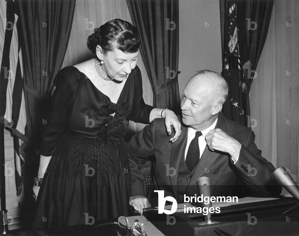 First Lady Mamie Eisenhower talks with the President before his Radio-TV address of Feb. 29, 1956. Five months after his heart attack, he announced he would run for a second term in the presidency.