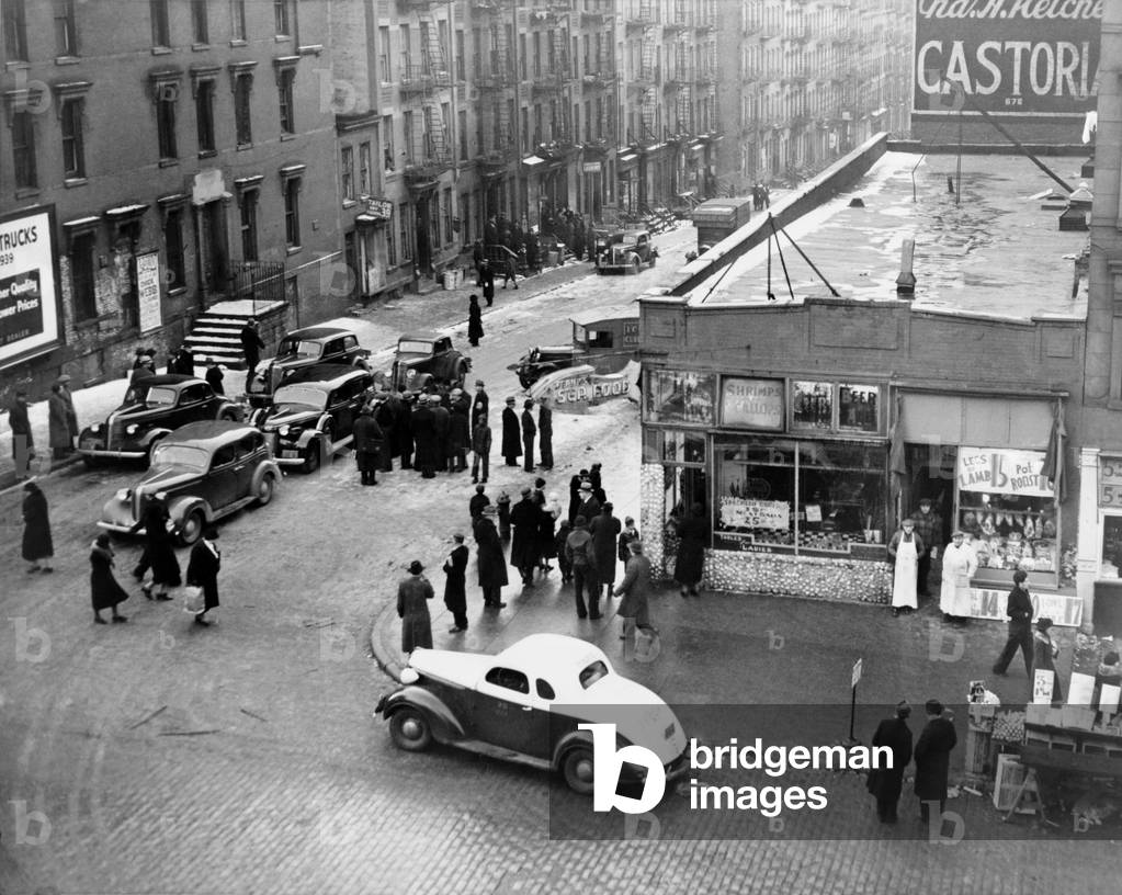 Federal Bureau of Narcotics agents blockade streets with their cars in a drug bust in the San Juan Hill neighborhood of New York City 1939