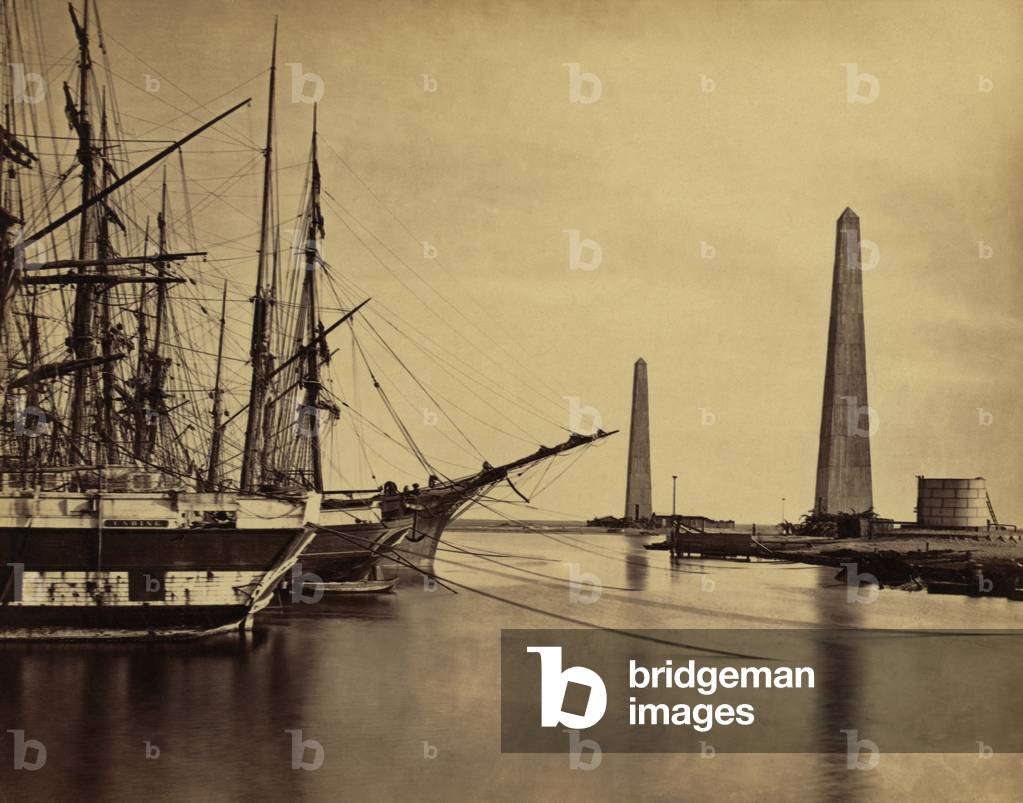 Obelisks on shore and ships moored at the Port Said entrance to the Suez Canal. 1860 photo by Francis Frith. LC-DIG-ppmsca-04472