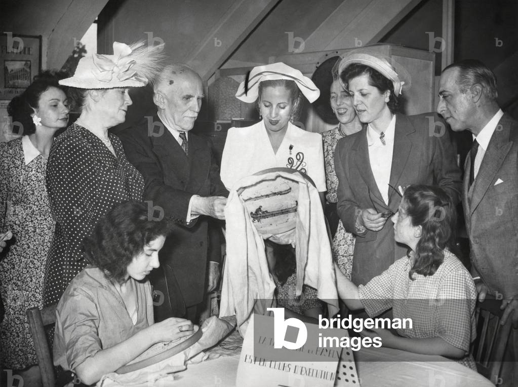 Eva Peron visiting a sewing workshop where women workers were engaged in embroidery. July 1947.