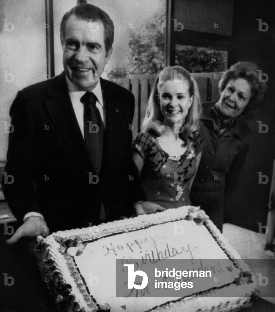 Nixon Presidency. US President Richard Nixon with daughter Tricia Nixon and First Lady Patricia Nixon on Nixon's birthday, Washington, D.C., January 9, 1974