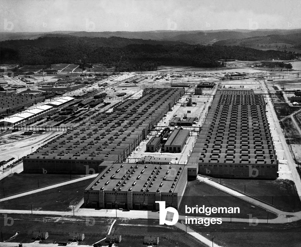 Aerial view of the K25 Plant at the Oak Ridge site of the Manhattan Project. This massive building housed the compressors and converters in which uranium hexafluoride was subjected to gaseous diffusion to separate fissionable uranium 235 from natural uranium 238. 1947 photo by Ed Westcott