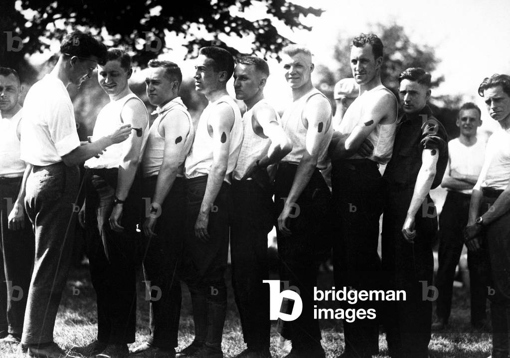 New recruits for the Army's Ambulance Corps are 'iodined' before receiving an inoculation. World War I. c. 1917