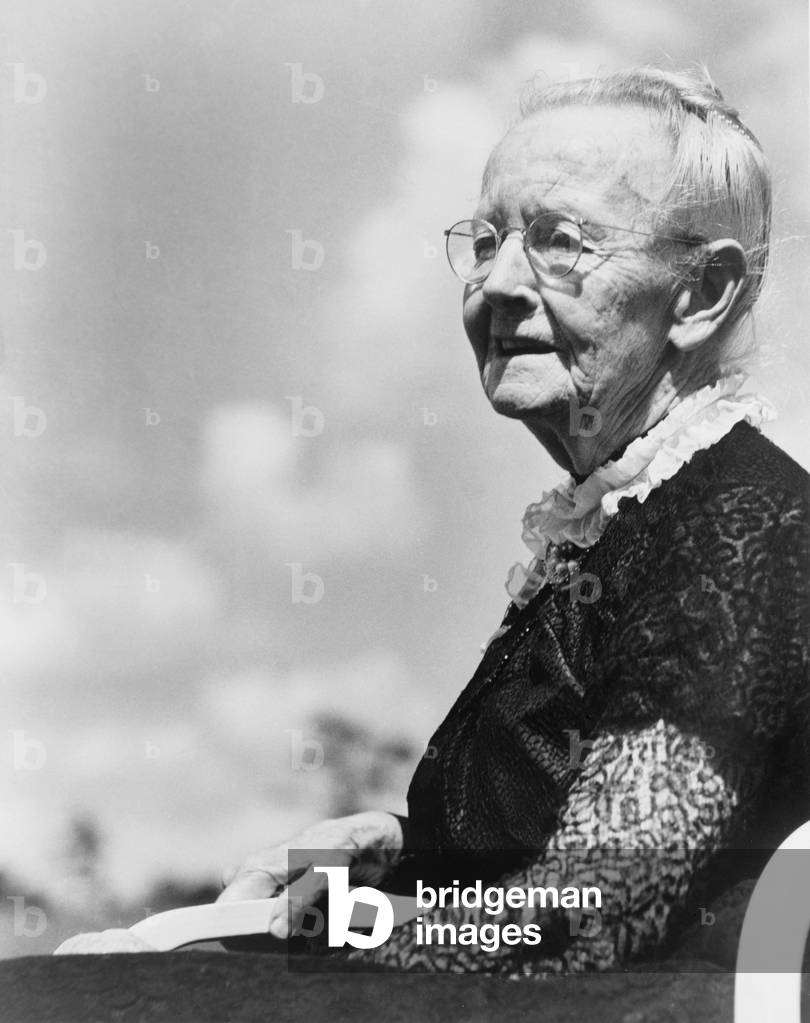 Grandma Moses, born as Anna Mary Robertson (1860-1961), began painting in her seventies and achieved acclaim as a folk painter. c. 1950 at age 90