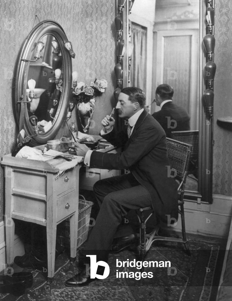 John Drew (1853-1927), American actor, seated at dressing table, in Empire Theatre, New York, 1902