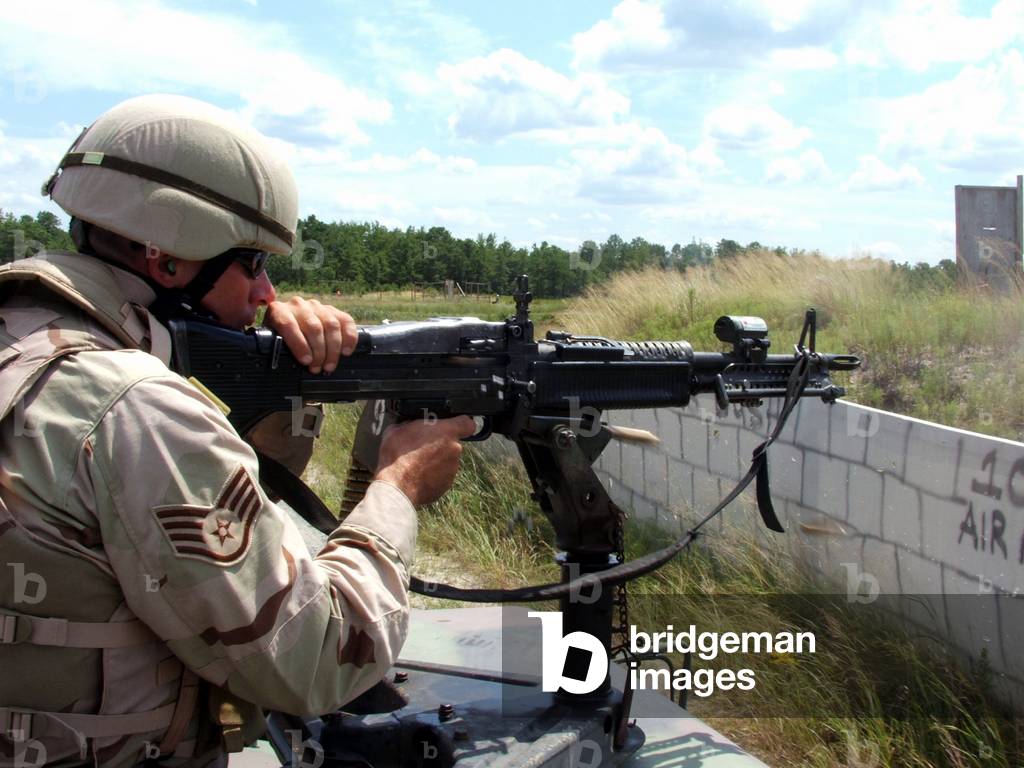 U.S. Air Force Staff Sgt. Damon L. Green shoots an M-60 machine gun on a training range during live-: U.S. Air Force Staff Sgt. Damon L. Green shoots an M-60 machine gun on a training range during live-fire target shooting operations for the Air Force Phoenix Warrior Course 06-1 at Fort Dix, N.J., Aug. 8, 2006.