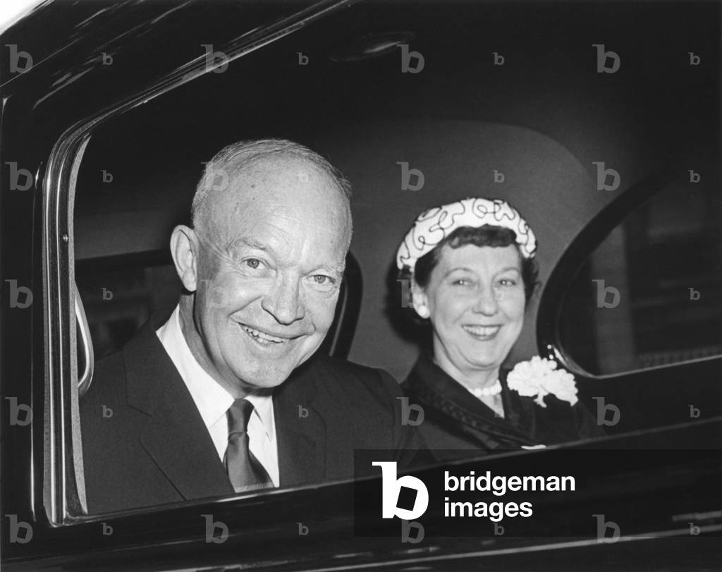President and Mamie Eisenhower smiling from a limousine. Eisenhower. August 8, 1956.