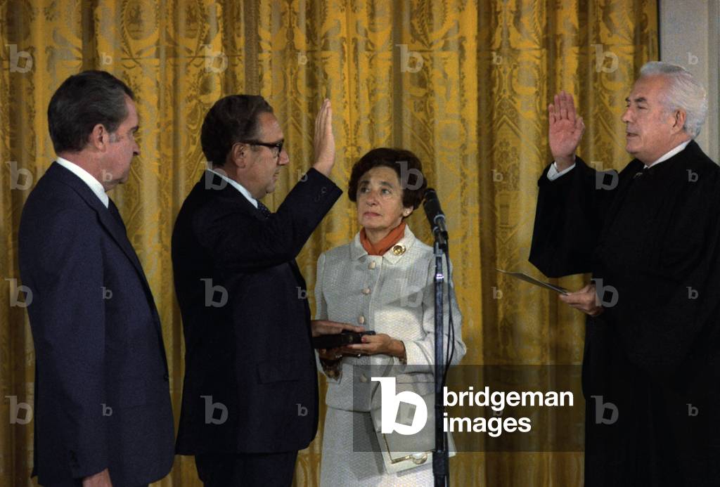 Henry Kissinger being sworn in as Secretary of State by Chief Justice Warren Burger. President Richard Nixon (L) watches while Kissinger's mother, Paula, holds the Bible upon which he was sworn in. Washington, D.C., September 22, 1973