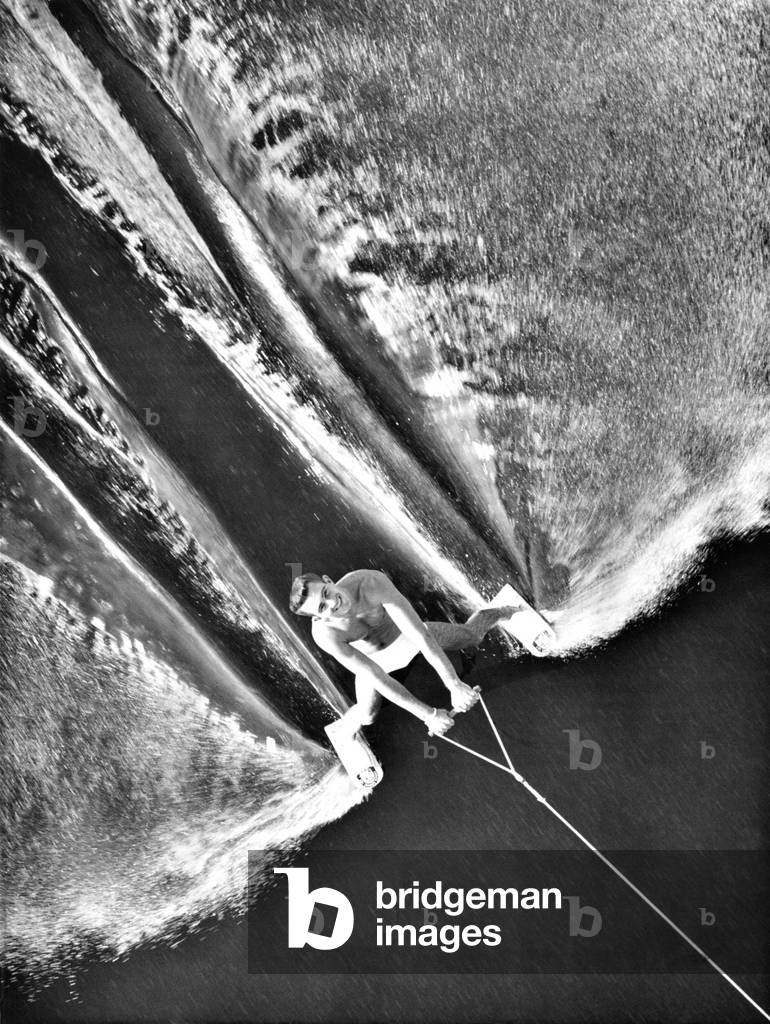 Water skier George Hughes passed under the bridge at Cypress Gardens, Florida. June 28, 1963. He wore only tiny shoe skis instead of the traditional long water skis