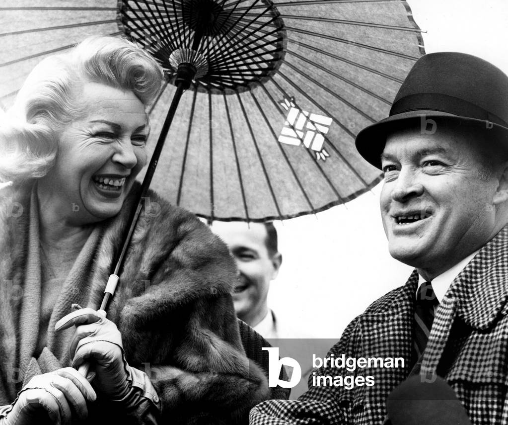 LANA TURNER and BOB HOPE enjoy a laugh during a 1940s USO reunion show, 1970s