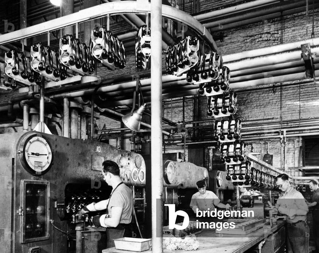 Men make phones for civilian use at Western Electric Company. They made thousands of phones for military use during the war, 1945