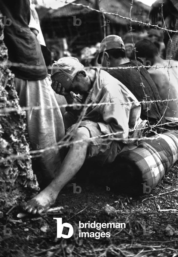 Japanese soldier sits dejectedly in a prisoner of war enclosure on Okinawa. June 1945, during World War 2