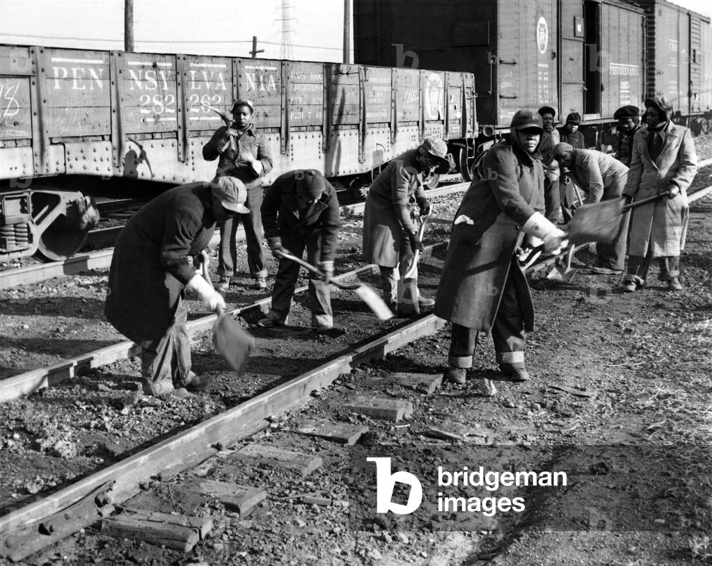 African American women working on a railroad crew. They perform track maintenance in near-zero weather in Chicago. They fill jobs vacated by men entering the military during World War II. Nov. 26, 1943