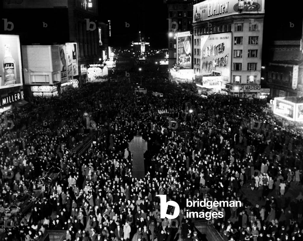 Thousands of people crowd Times Square awaiting the New Year, South from Duffy Square, New York City, December 31, 1945