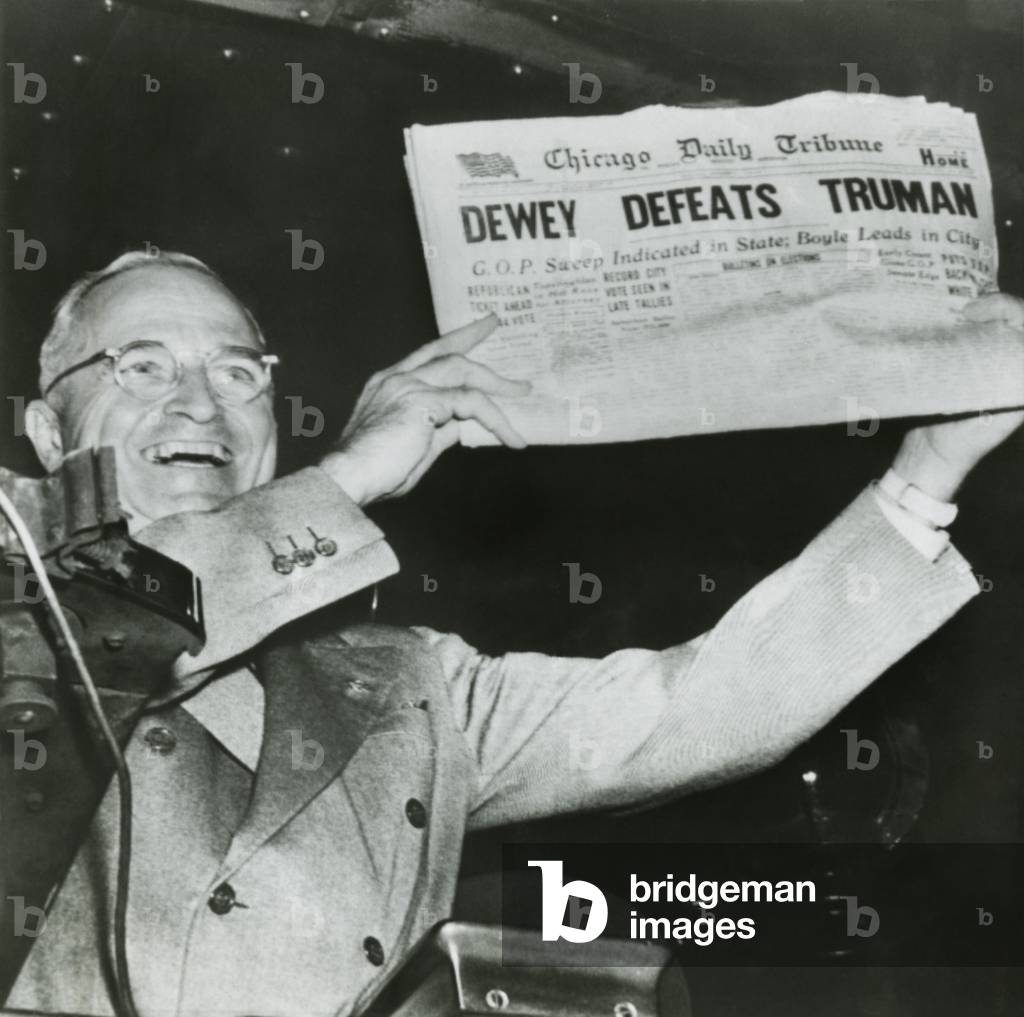 Harry S. Truman, president-elect, holds up edition of Chicago Daily Tribune with headline 'Dewey Defeats Truman'. The Republican newspaper followed the public polls predictions that Truman would be defeated by Dewey. Instead, Truman won with electoral votes to spare and a 49.6 % of the popular vote to Dewey's 45.1 %. Nov. 3, 1948.