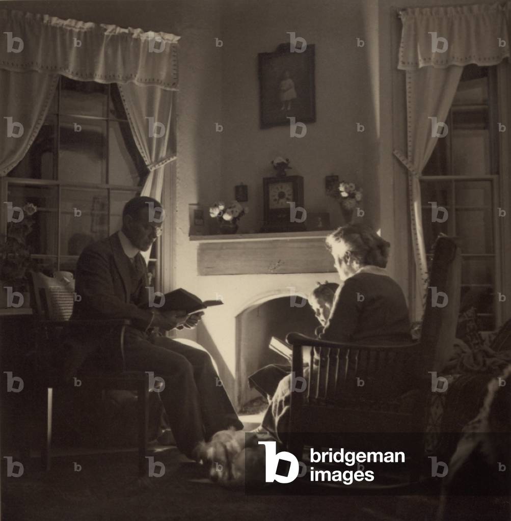 Family reads at the fireside. 1935
